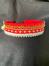 Load image into Gallery viewer, Red headband with intricate patterns on a black background